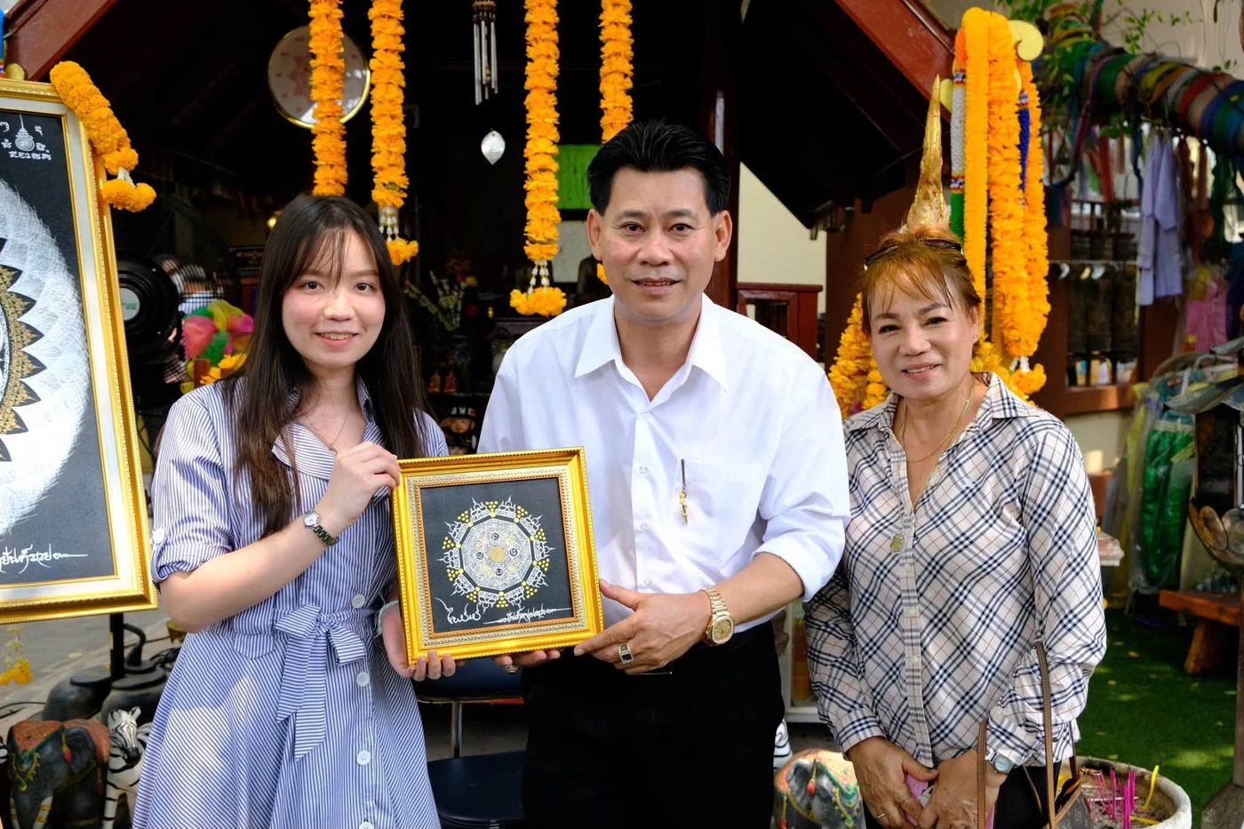 Master Phairot with customers and the Fortune-Opening Yantra